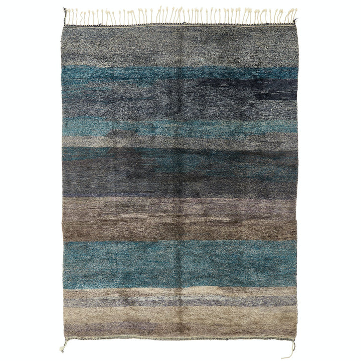 Handwoven wool rug with gradient stripes in shades of blue.