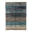 Handwoven wool rug with gradient stripes in shades of blue.