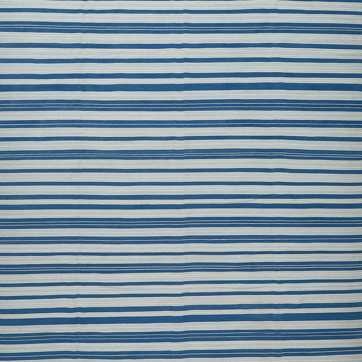 Abstract patterned surface with alternating stripes of white and blue