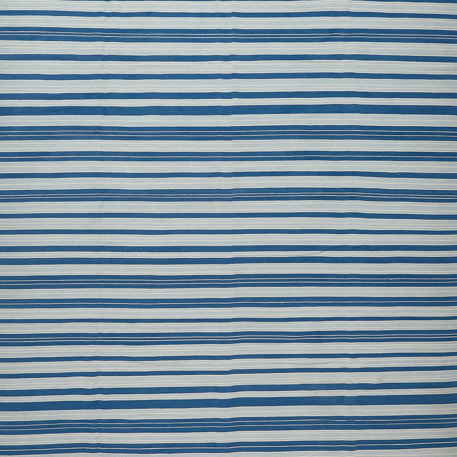 Abstract patterned surface with alternating stripes of white and blue