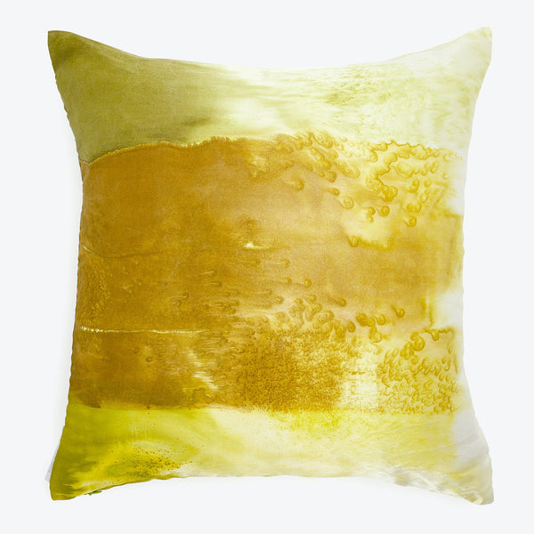 Decorative pillow with a fluid watercolor-like design in green and yellow tones.