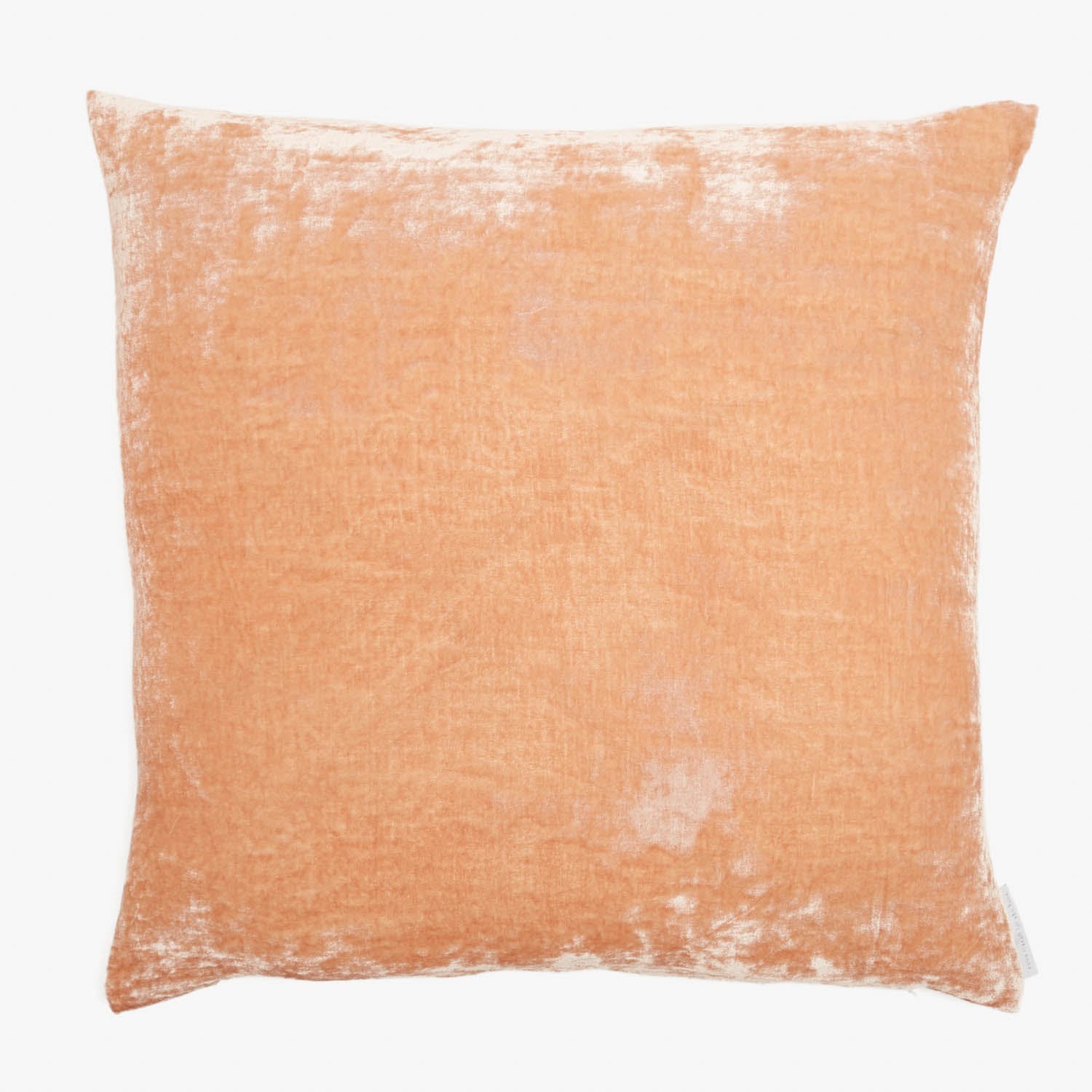 Peach-colored square pillow with distressed finish and clean design.