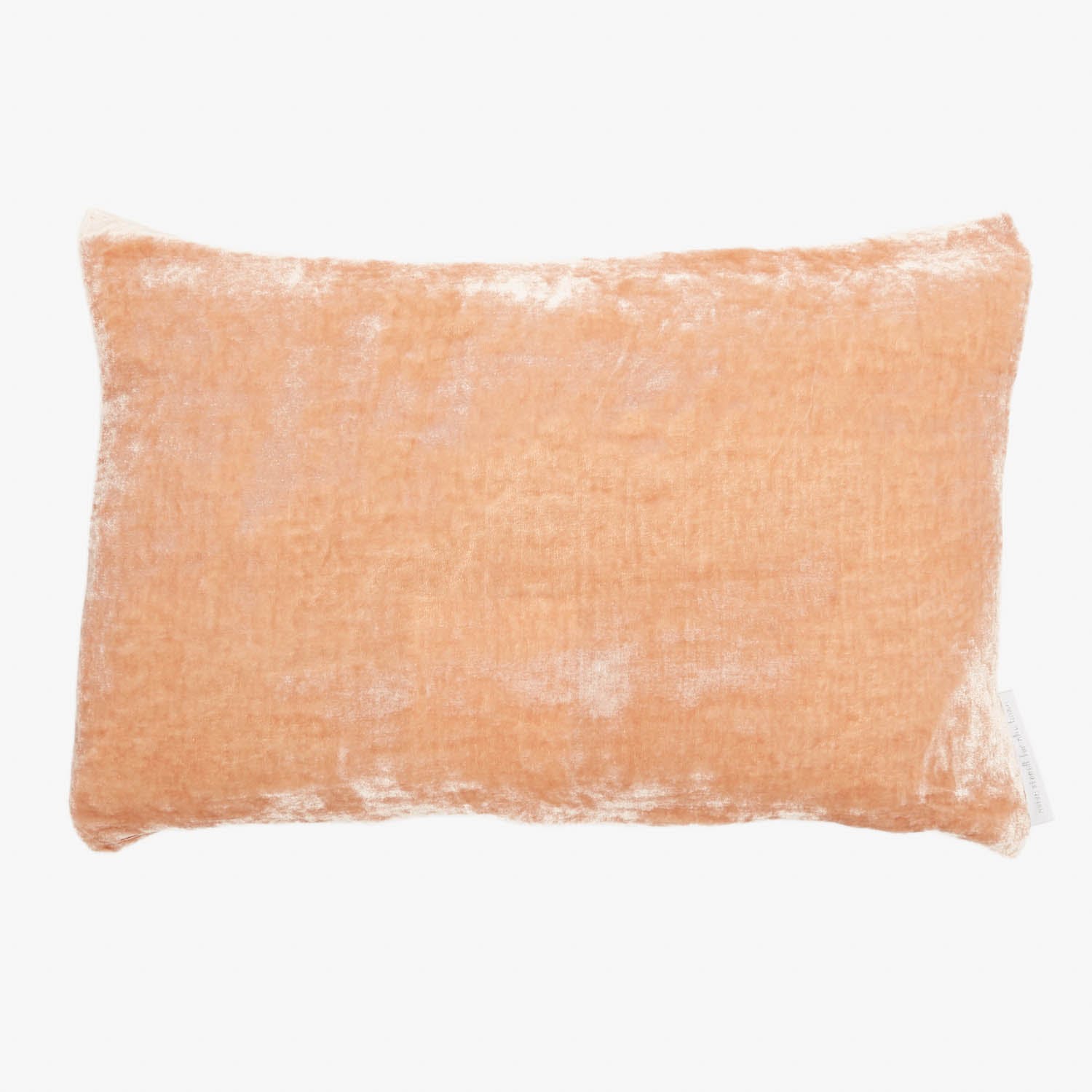 Soft, plush rectangular pillow in pale orange color on white background.