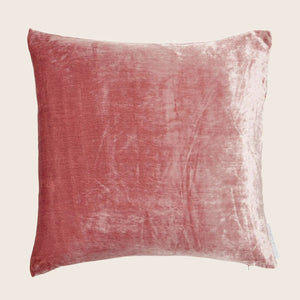 Dusty rose velvet cushion with subtle sheen and visible seam.