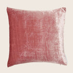 Dusty rose velvet cushion with subtle sheen and visible seam.