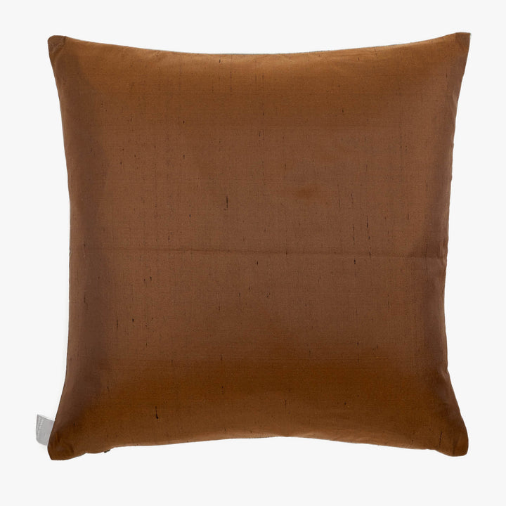 Brown square pillow with faint fabric texture and white tag.