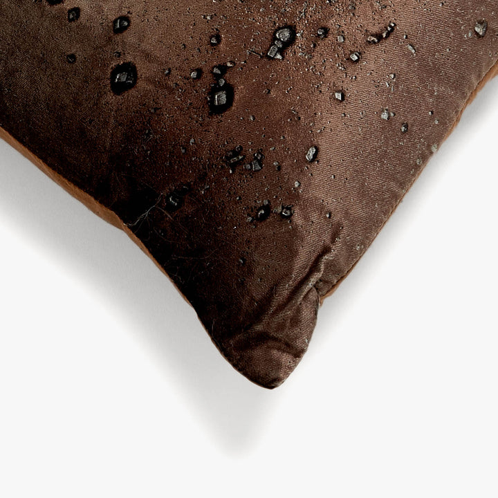 Close-up of dark chocolate bar with salt or sugar inclusions.