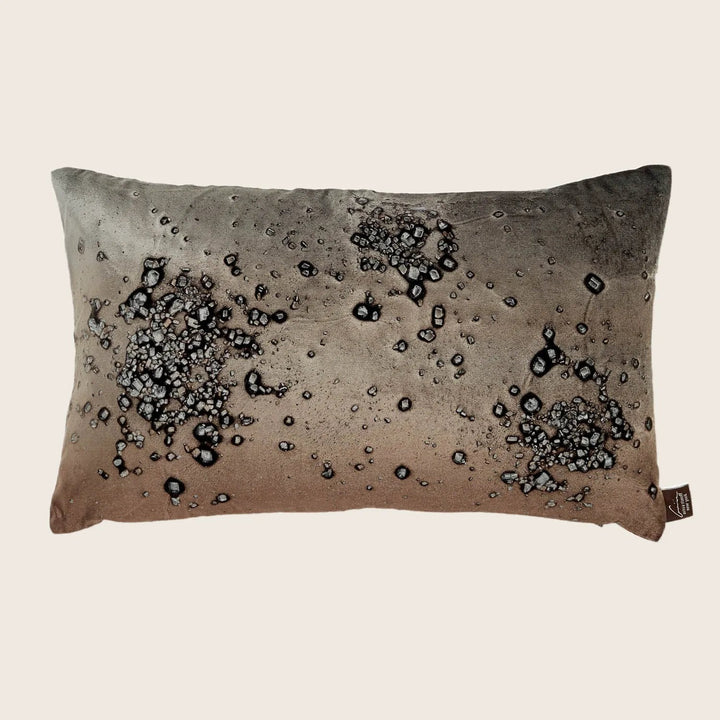 Rectangular decorative pillow with gradient color design and water droplet effects.