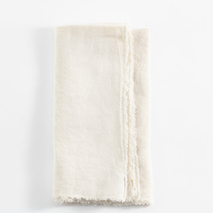 Folded light-colored fabric with fraying edges and noticeable crease.