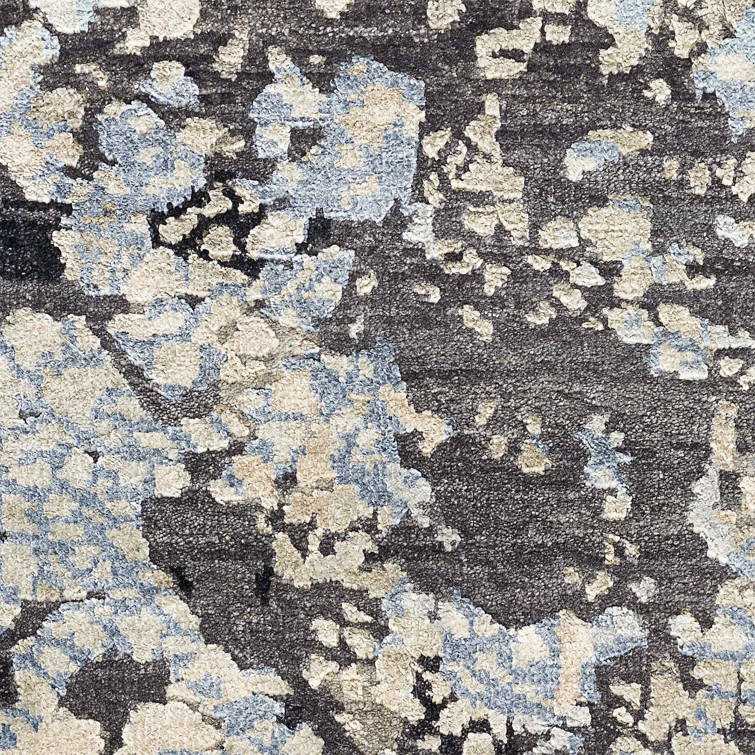 Abstract patterned carpet with cream and blue splashes on dark background.