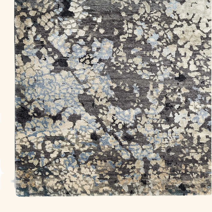 Close-up view of a modern abstract rug with soft, varied colors.