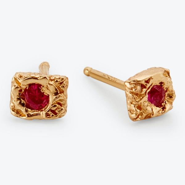 Elegant gold stud earrings with textured design and vibrant gemstones.