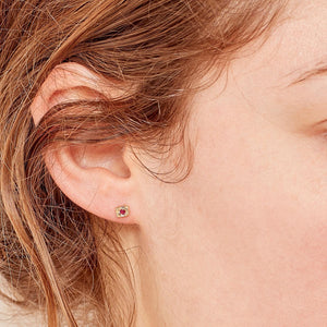 Elegant gold stud earrings with textured design and vibrant gemstones. - hover