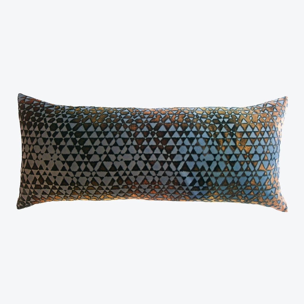 A geometric lumbar pillow with a vibrant kaleidoscopic triangle pattern.