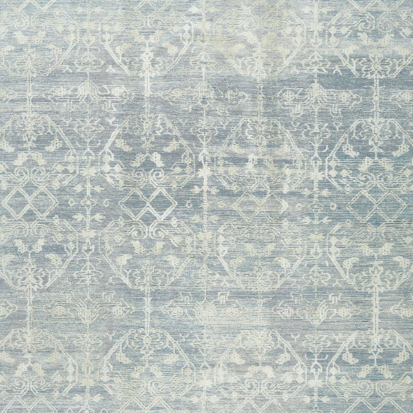 Vintage-inspired textured surface with symmetrical motifs in muted blues.