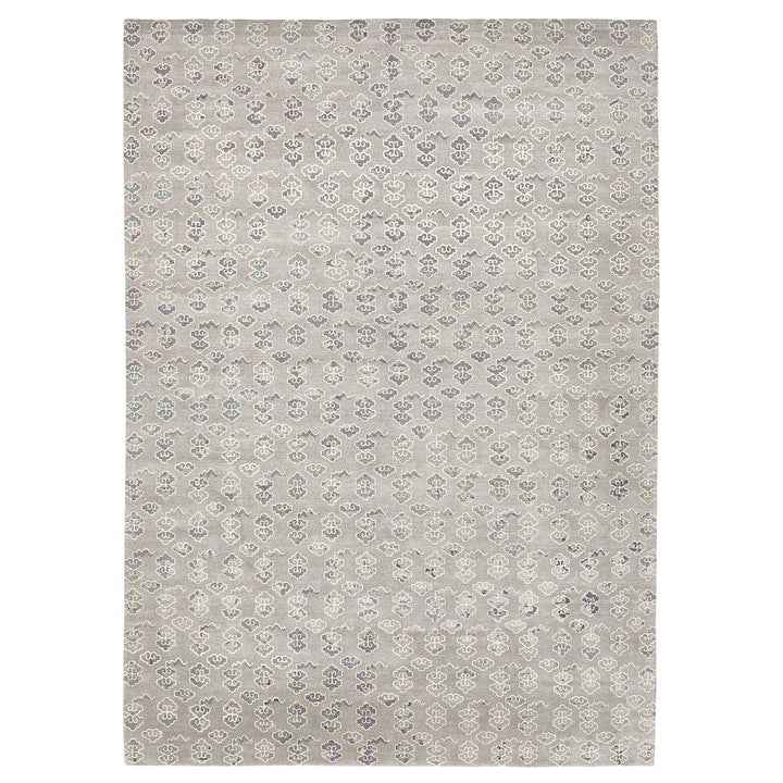 Rectangular rug with elegant floral motifs in muted gray tones.