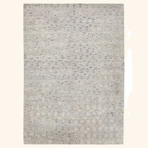 Rectangular rug with elegant floral motifs in muted gray tones.