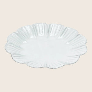 Elegant white plate with textured surface and ruffled rim design. - hover