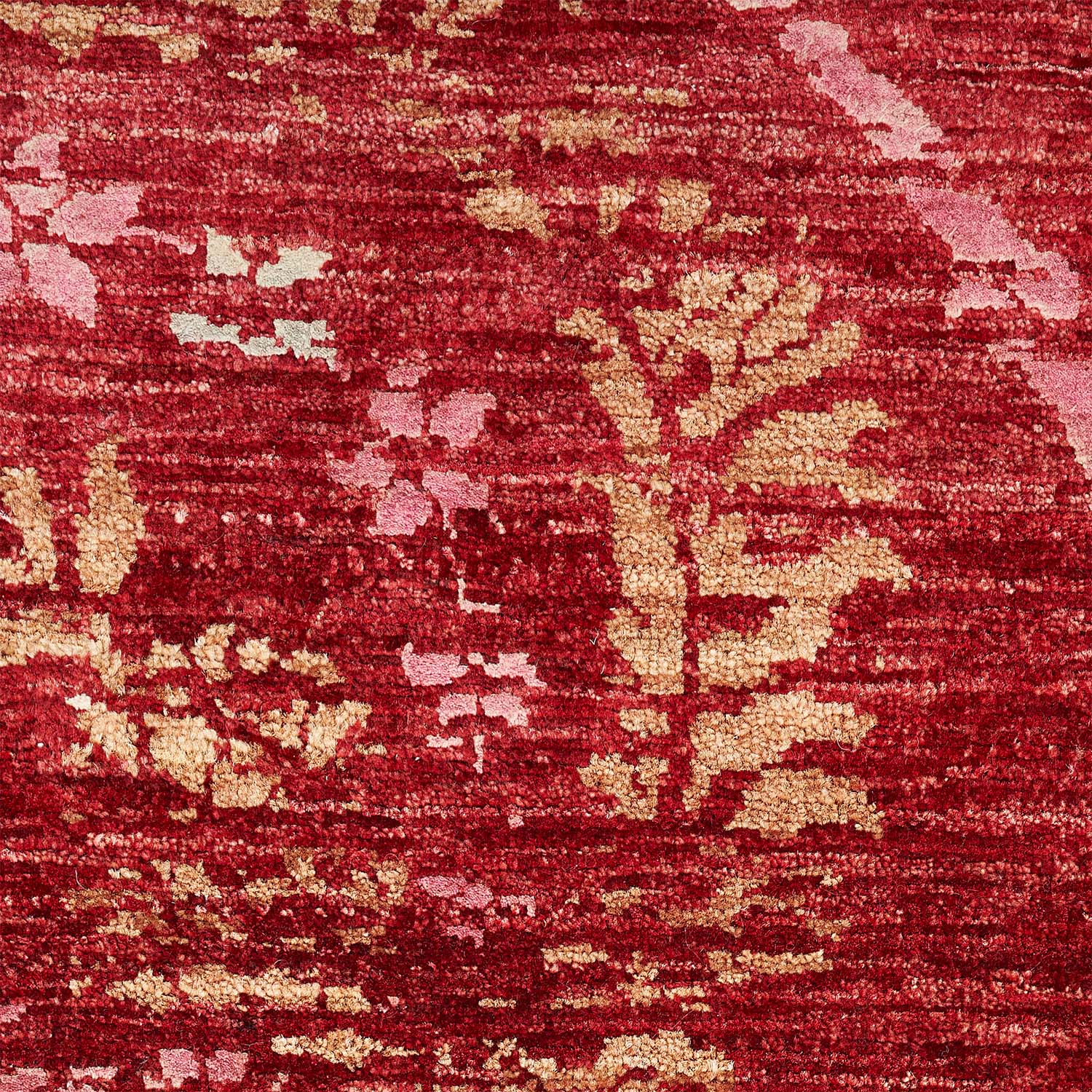 Close-up of a red textured fabric with abstract distressed pattern.