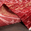 Close-up view of a folded red and beige patterned rug.