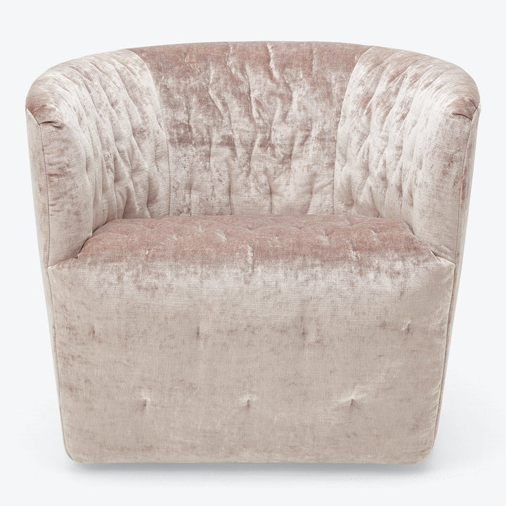 Elegant barrel chair with tufting details and soft velvet fabric.