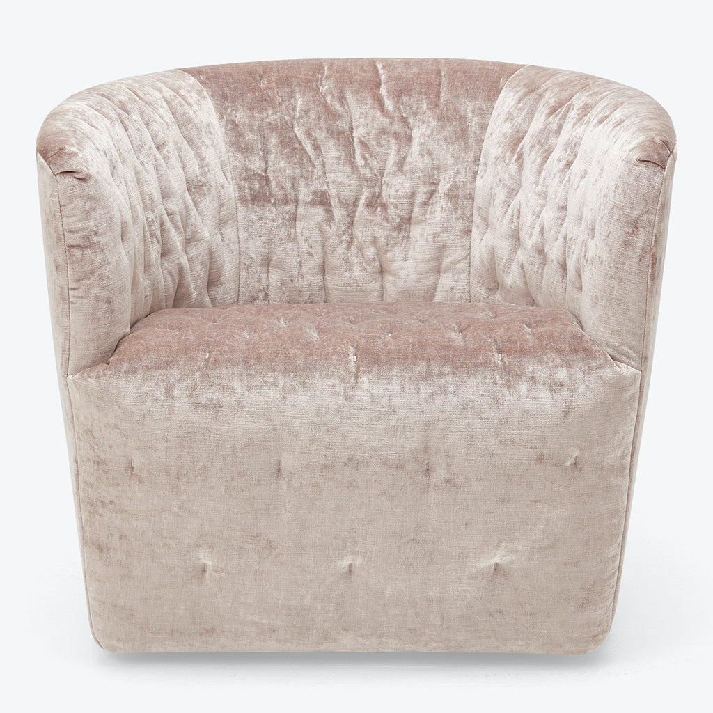 Elegant barrel chair with tufting details and soft velvet fabric.