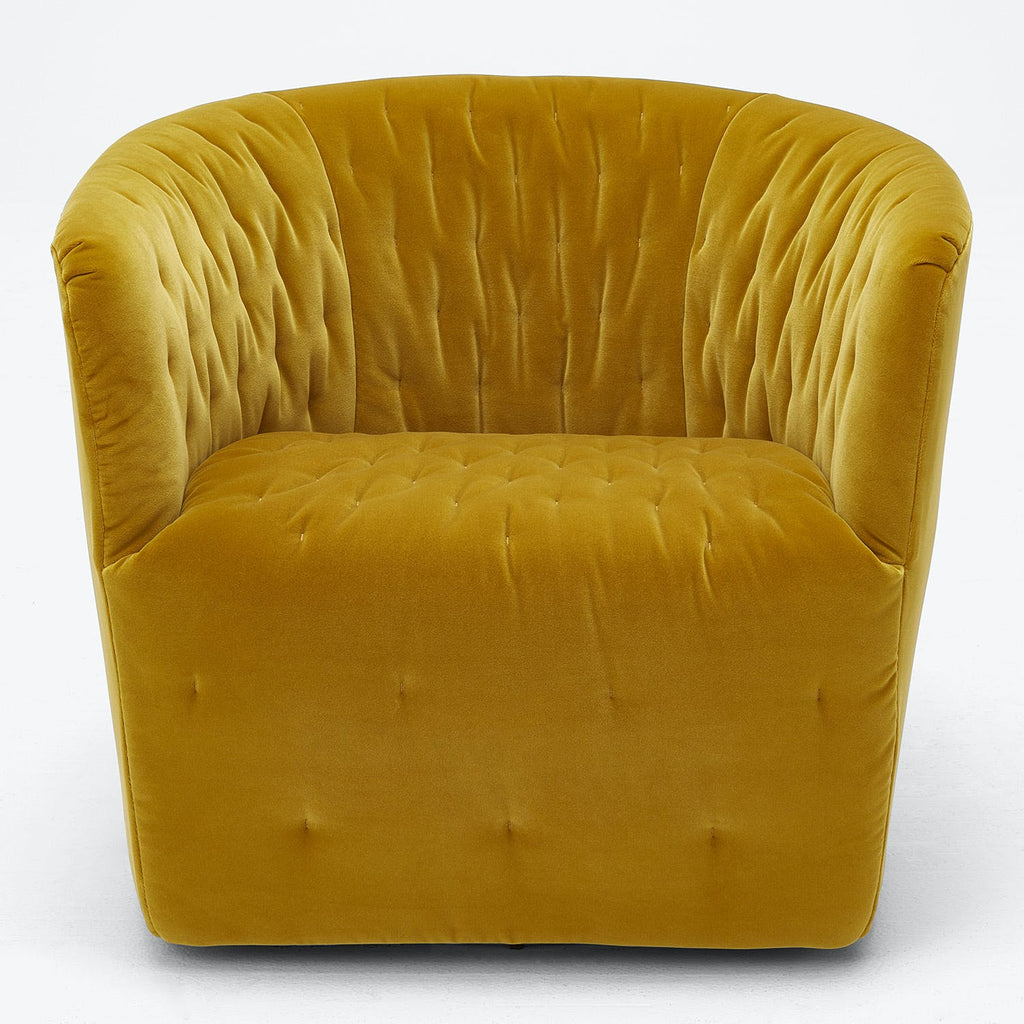 Mustard yellow armchair with plush tufted design exuding luxury and comfort.