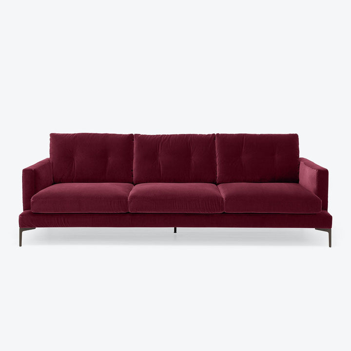 Contemporary three-seater sofa with plush burgundy velvet upholstery design.