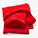 A warm and plush red quilted comforter, perfect for winter.