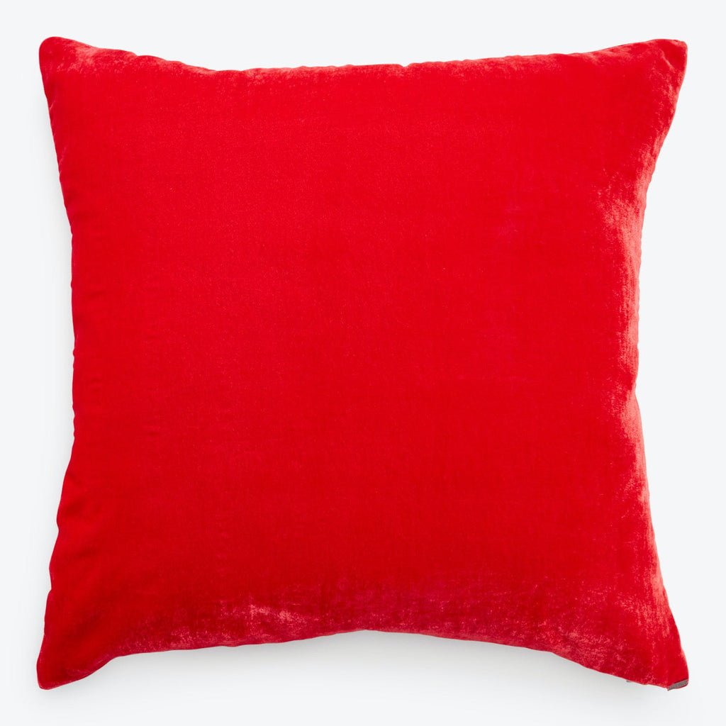 Vibrant red velvet pillow with plush texture and luxurious sheen.
