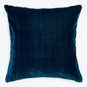 Deep blue velvet square pillow exudes elegance against white backdrop.