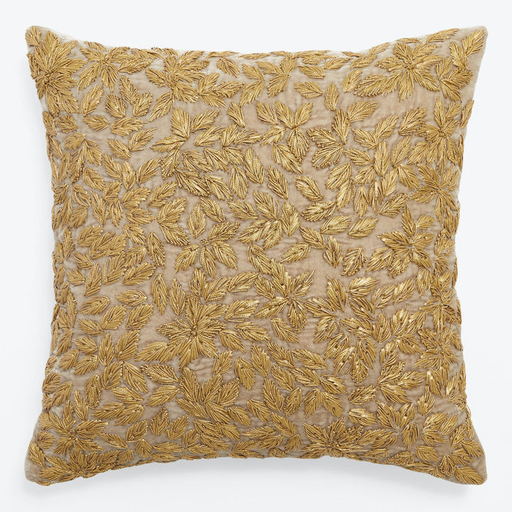 Square decorative pillow with gold embroidered foliage design exudes elegance.