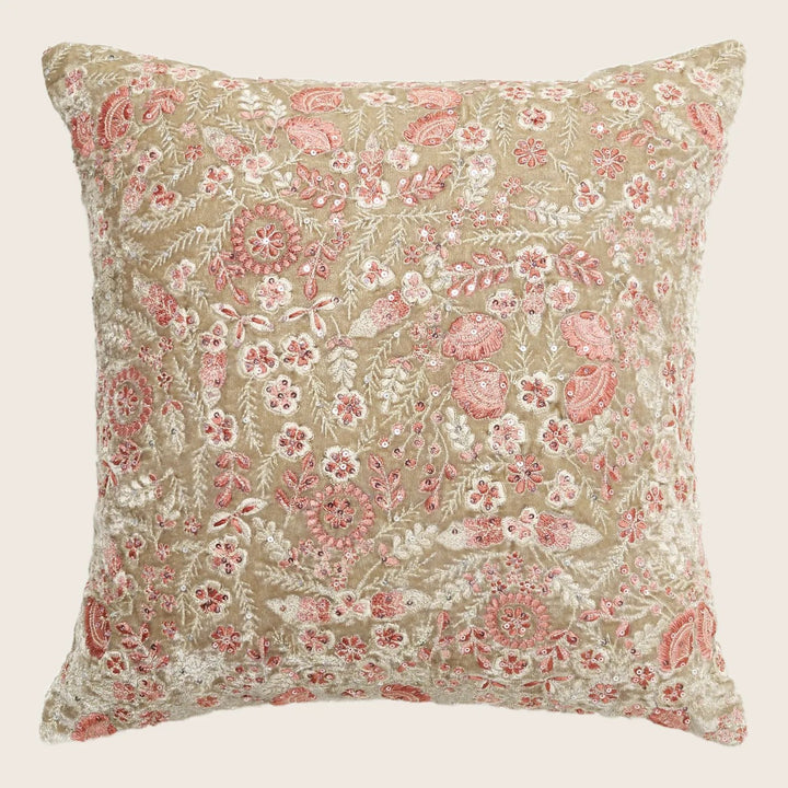 Intricately embroidered floral pillow adds a vintage touch to interiors.