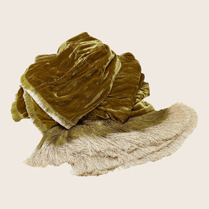 Soft and velvety olive green fabric with decorative fringe detailing.