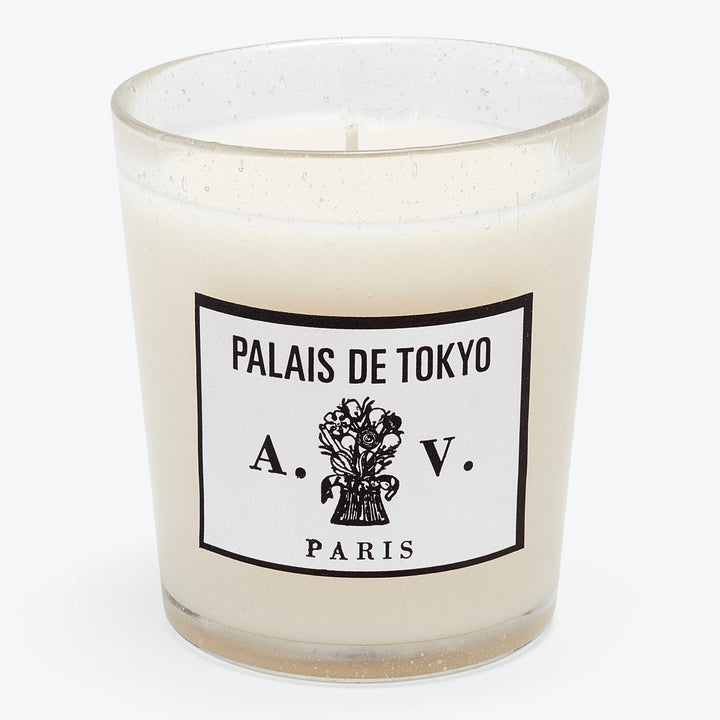 Unlit, off-white scented candle in chic Palais de Tokyo container.