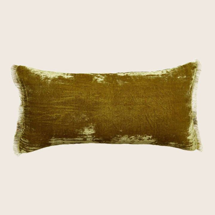 Luxurious olive green plush pillow with fringe detail on white background