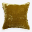 Golden-brown velvet square pillow with fringe, adding elegance and comfort.