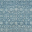 Intricate blue and white textile with vintage ornamental floral pattern.