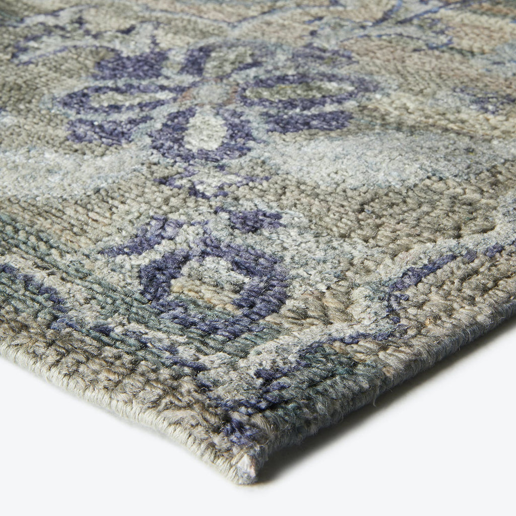 Close-up of a plush, textured rug with a floral pattern.