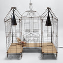 Elaborately designed, ornate birdcage resembling a miniature palace or house.