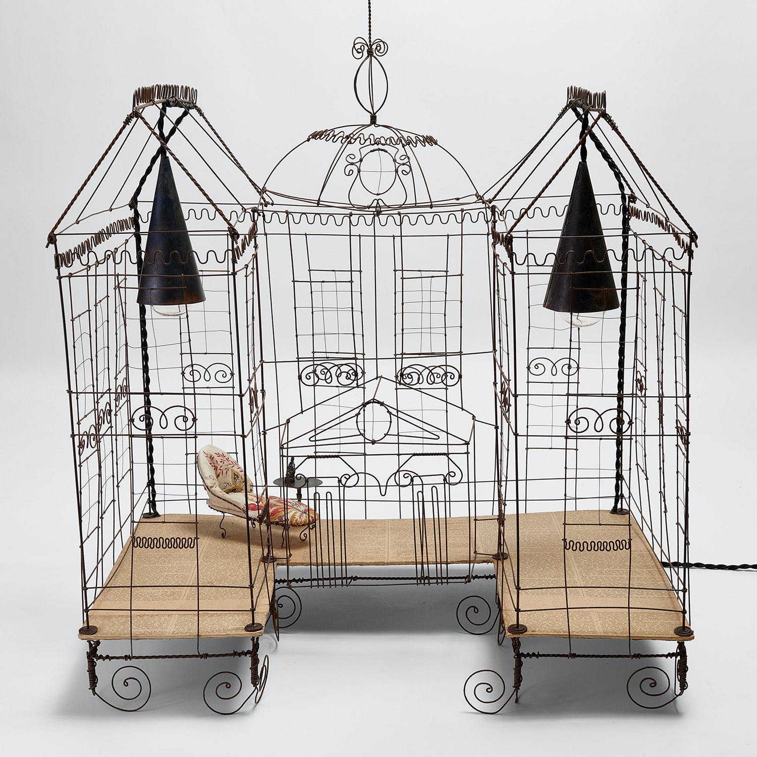 Elaborately designed, ornate birdcage resembling a miniature palace or house.