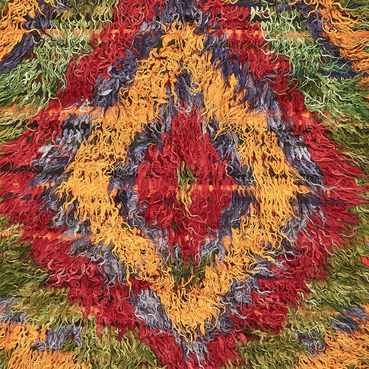 Vibrant, textured surface with a flowing, organic pattern in warm hues.