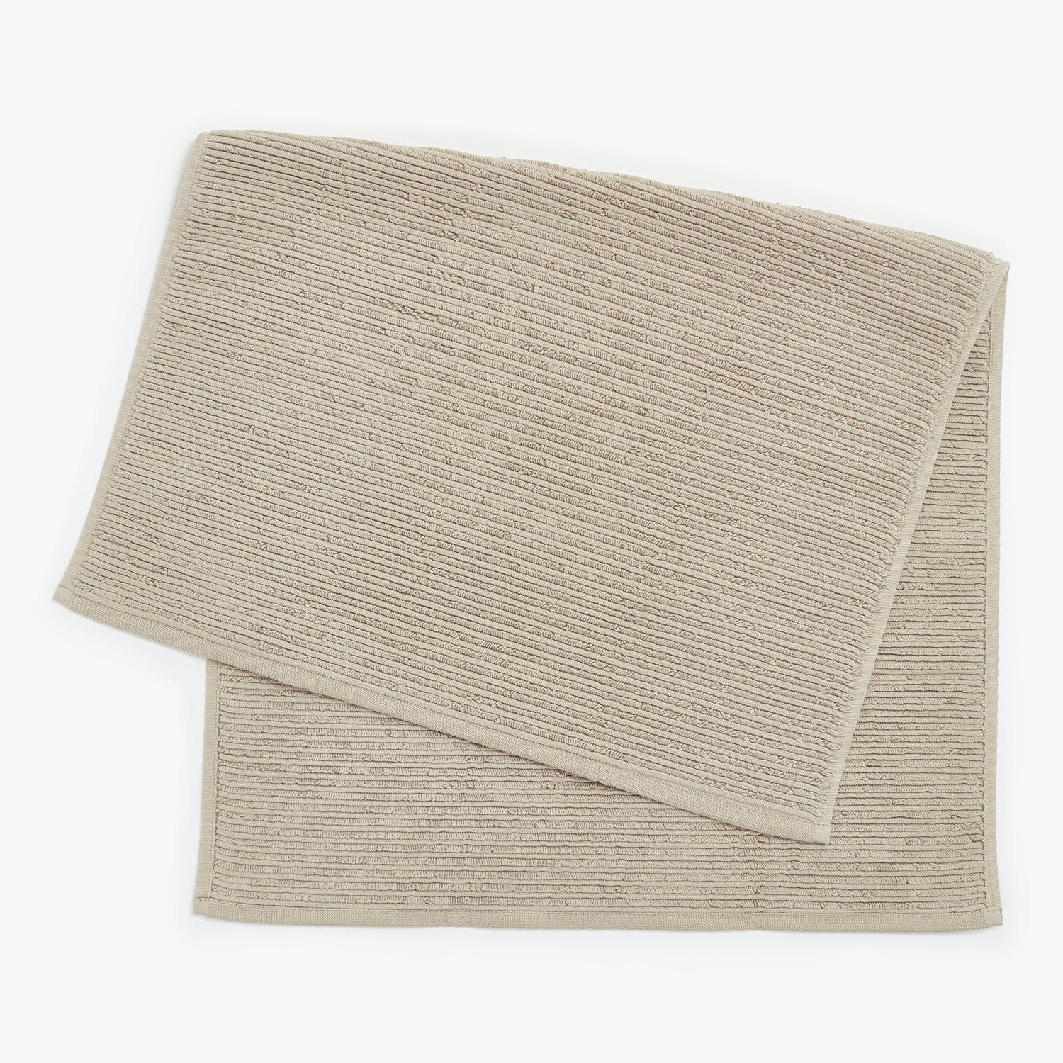 Neatly hemmed beige towels with ribbed design for various uses.