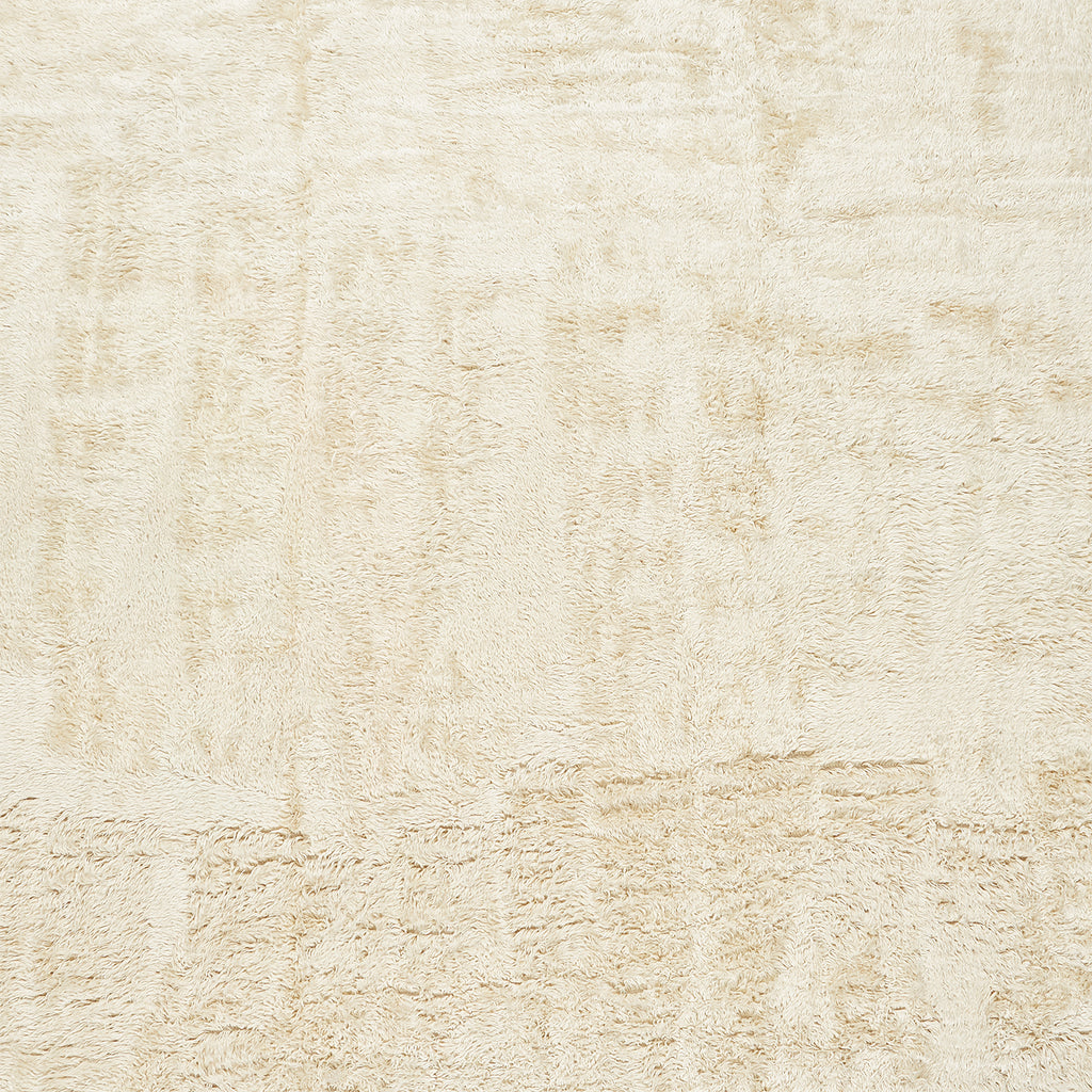 Close-up of a cozy, fluffy beige fabric with varied textures.