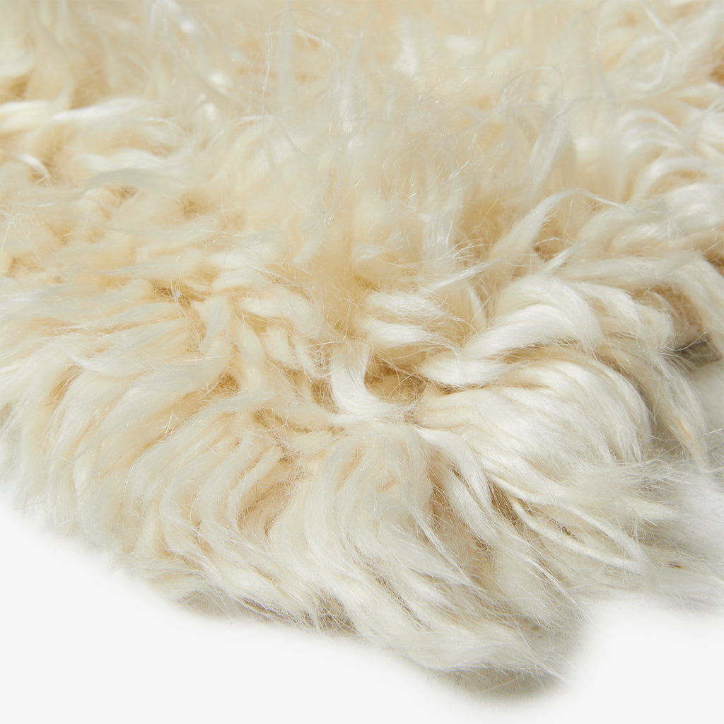 Close-up of soft, fluffy fibers resembling wool or synthetic material.