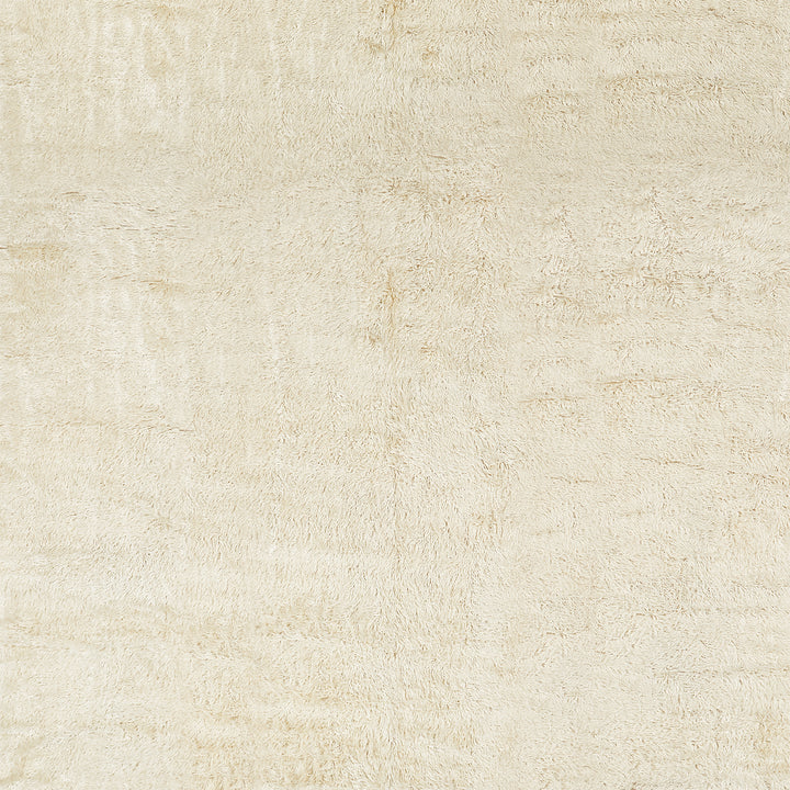 Close-up of a soft, textured cream-colored plush material surface.