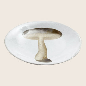 Handmade, textured white plate with a stylized mushroom design.