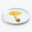 Artistic white ceramic plate with a yellow mushroom illustration.