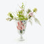 A beautiful arrangement of assorted flowers and plants in a classical vase.