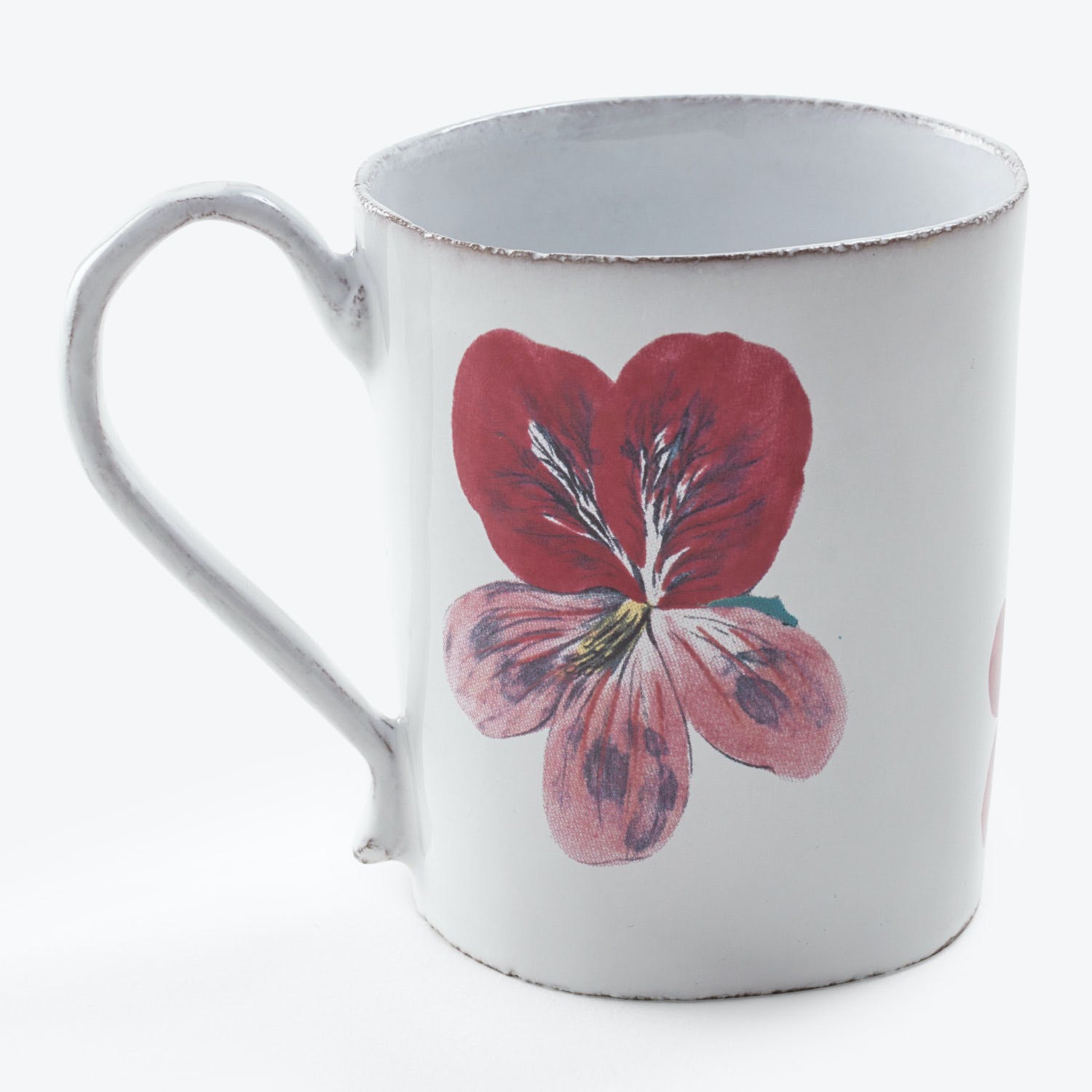 Vintage white enamel mug adorned with a vibrant red flower.